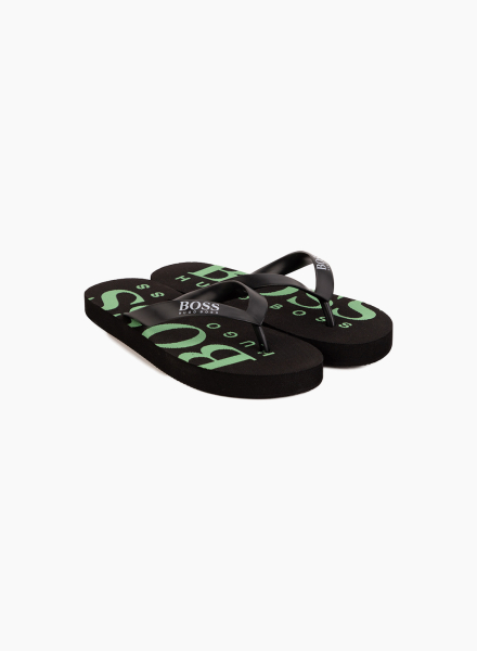 Flip flops with a logo on a sole
